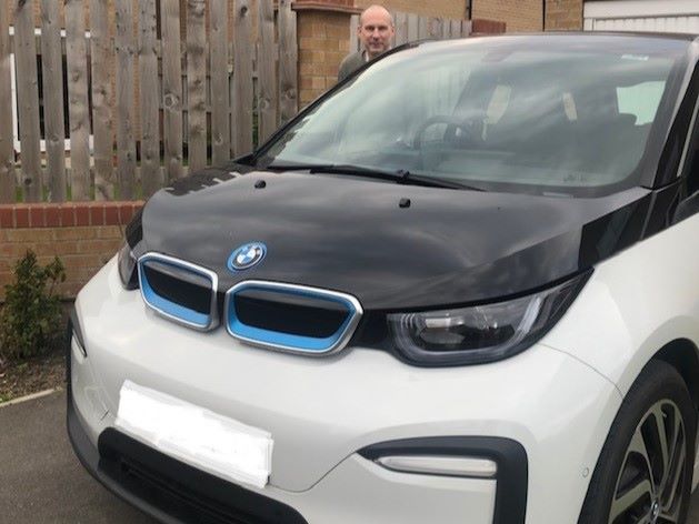 Jon standing behind his BMW i3 120 Ah 2020.
