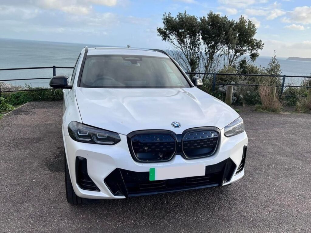 Mark Evans's BMW iX3 M Sport Pro parked by the sea.