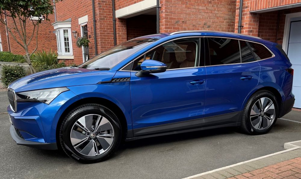 Blue Skoda Enyaq on owners driveway