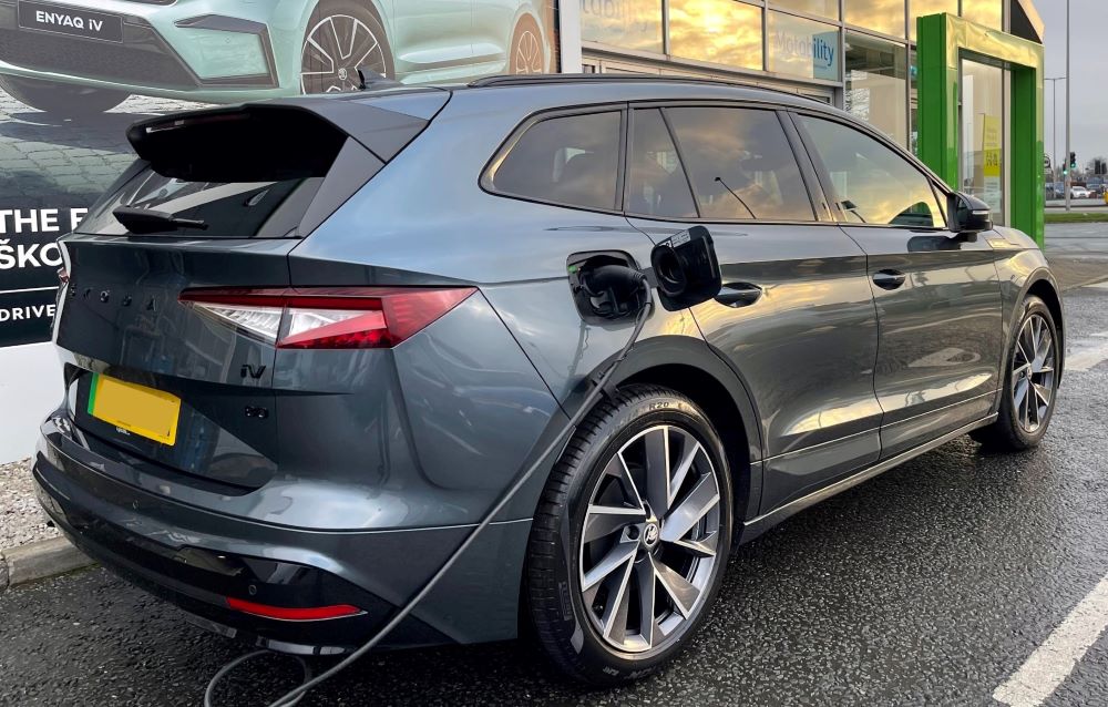 Grey Skoda Enyaq charging at Skoda dealership