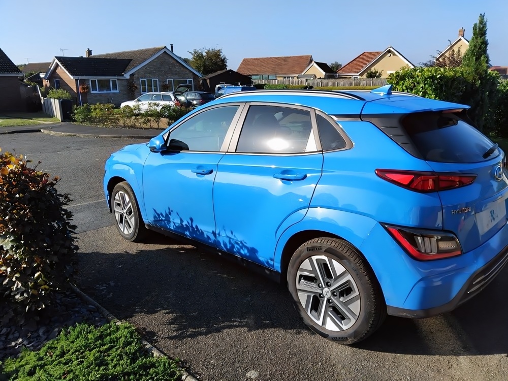 A rear three quarters view of Geoff's Hyundai Kona Electric parked on his driveway