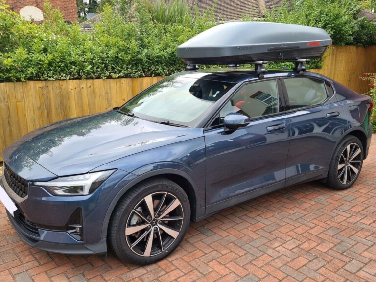 Polestar 2 on owners driveway with roof storage box