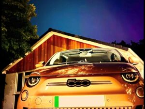 A FIAT 500e La Prima 42kWh 2022 parked in front of a residential property