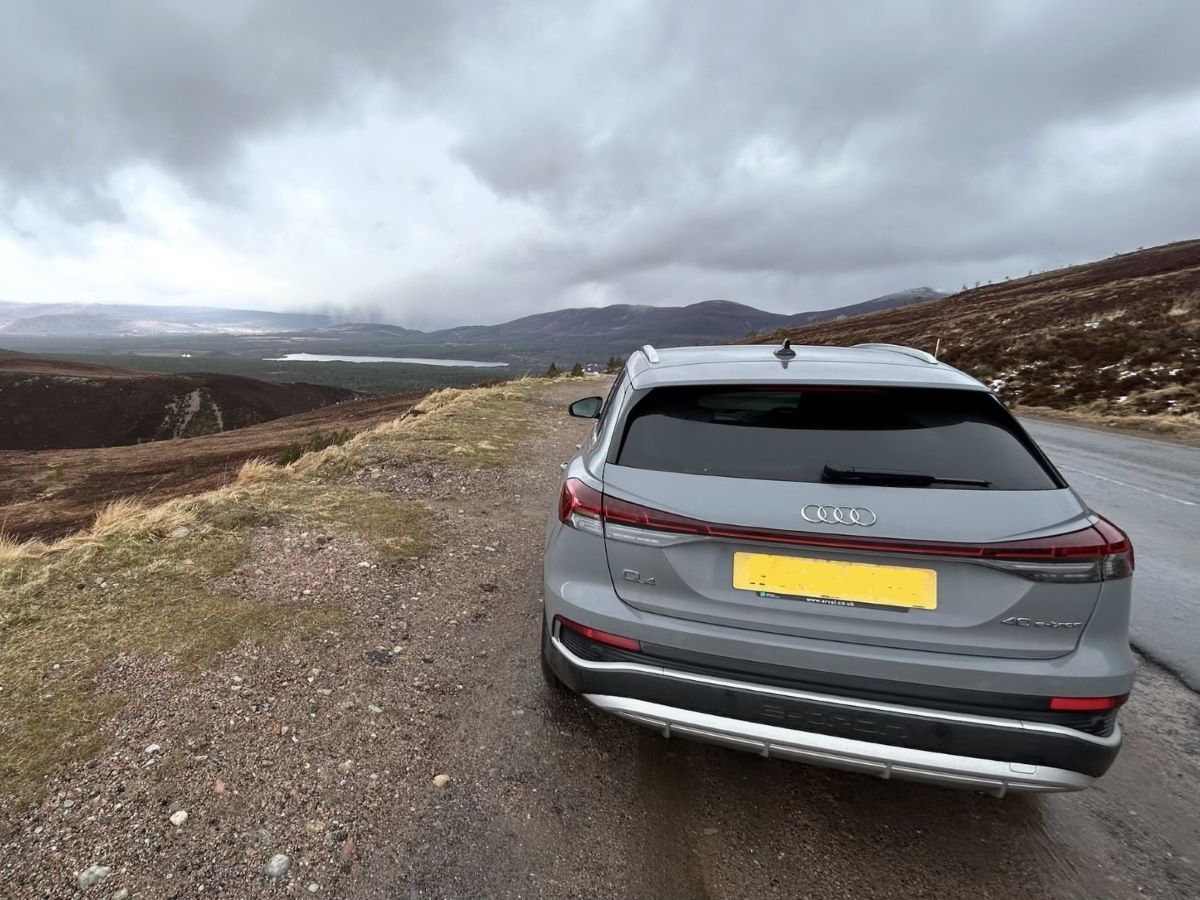 Rear three-quarter view of an Audi Q4 e-tron 40 S line on a scenic UK moorland road