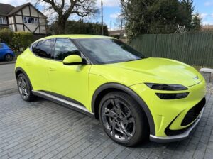 A Genesis GV60 Sports Plus parked on a driveway