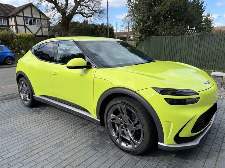 A Genesis GV60 Sports Plus parked on a driveway