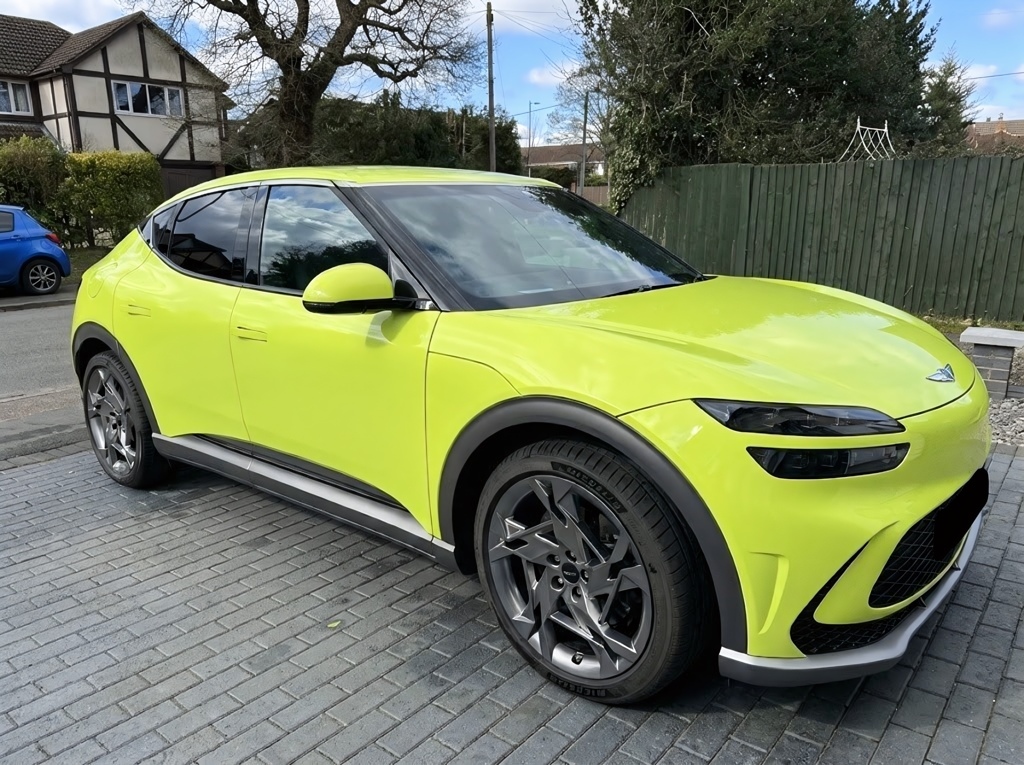 A Genesis GV60 Sports Plus parked on a driveway