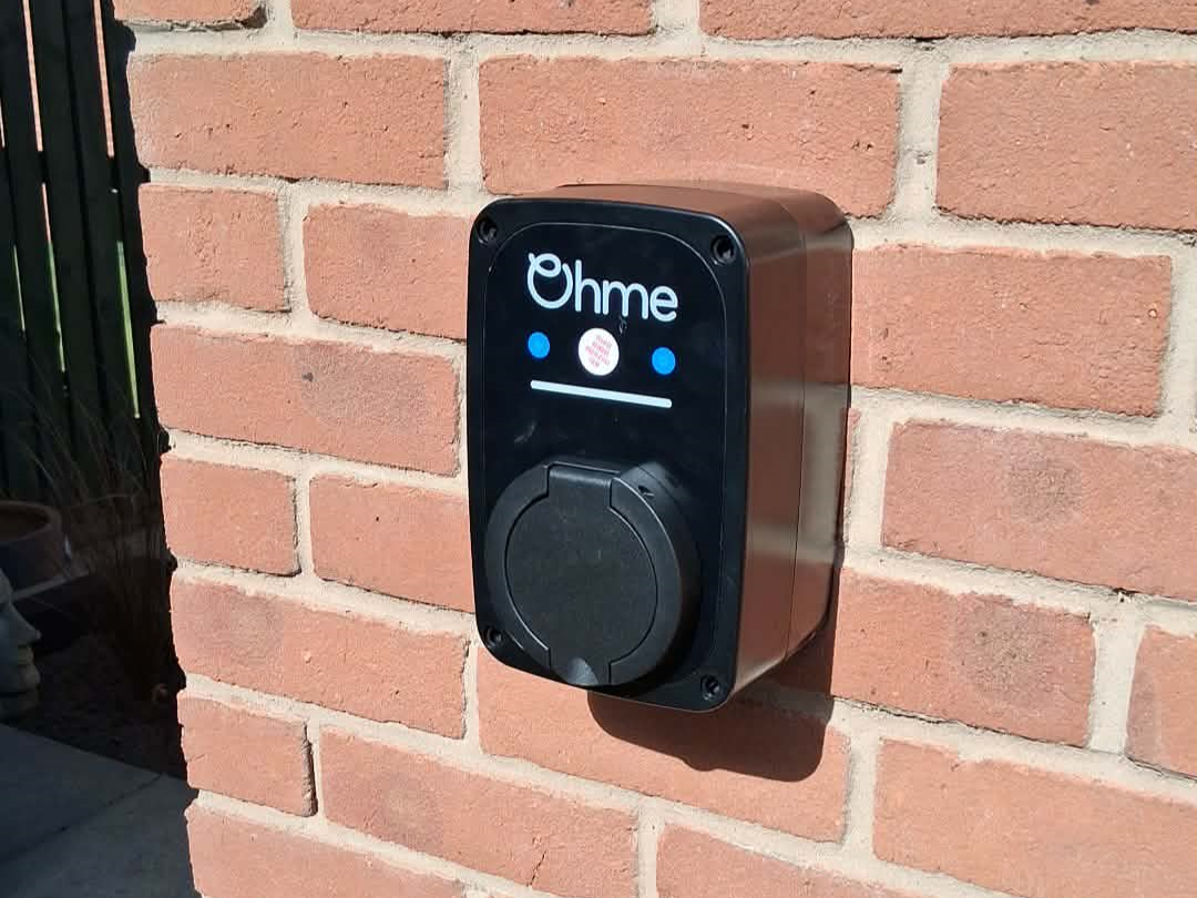 Ohme ePod smart home EV charger mounted on a brick wall used to charge a 2024 MG4 EV Trophy