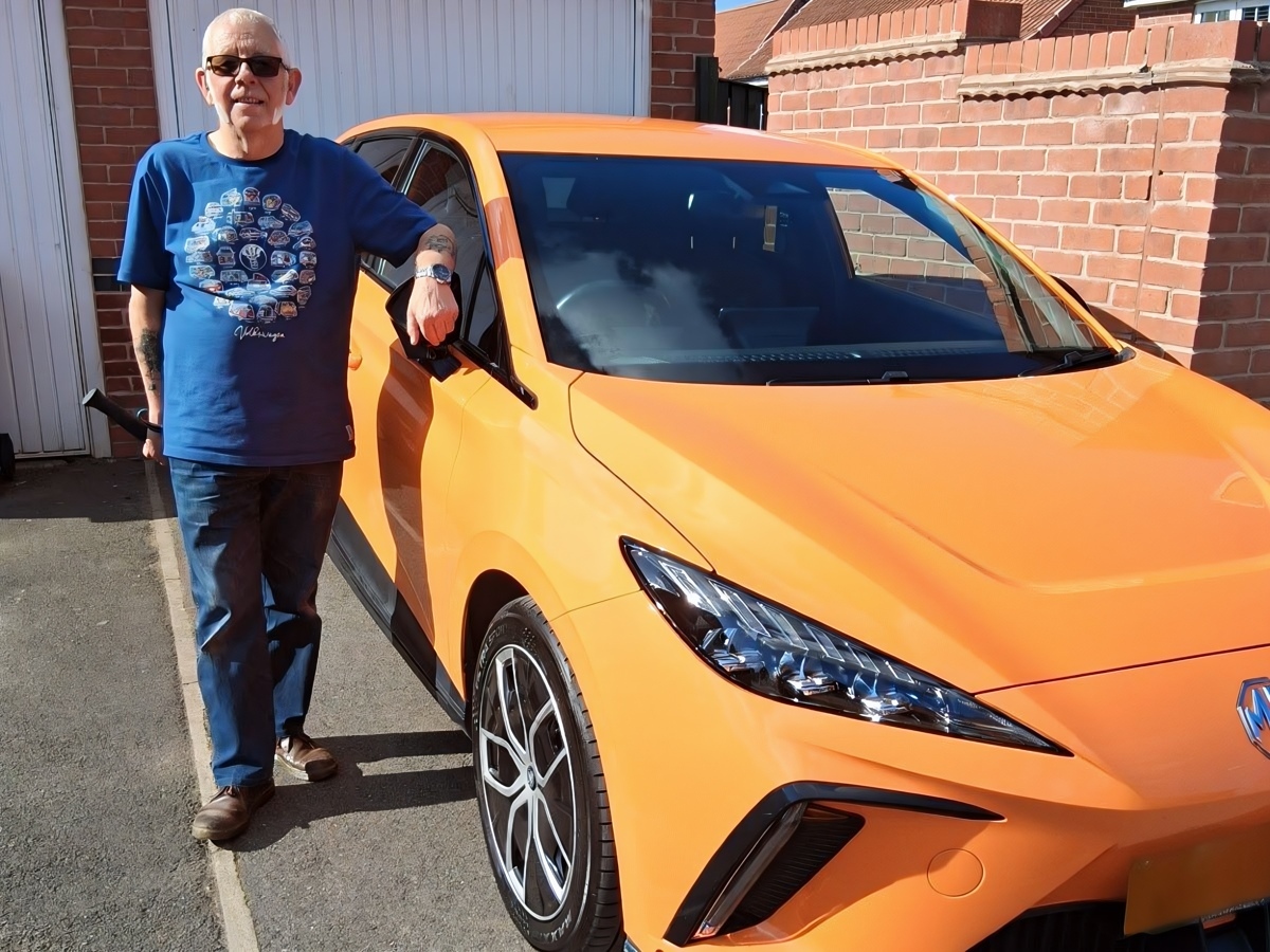 Owner Neil standing next to his Volcano Orange 2024 MG4 EV Trophy Long Range 64kWh electric hatchback