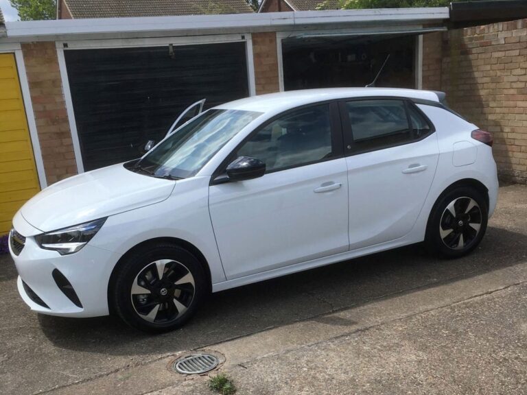 Mick Woolley's Vauxhall Corsa-e parked up in front of some garages